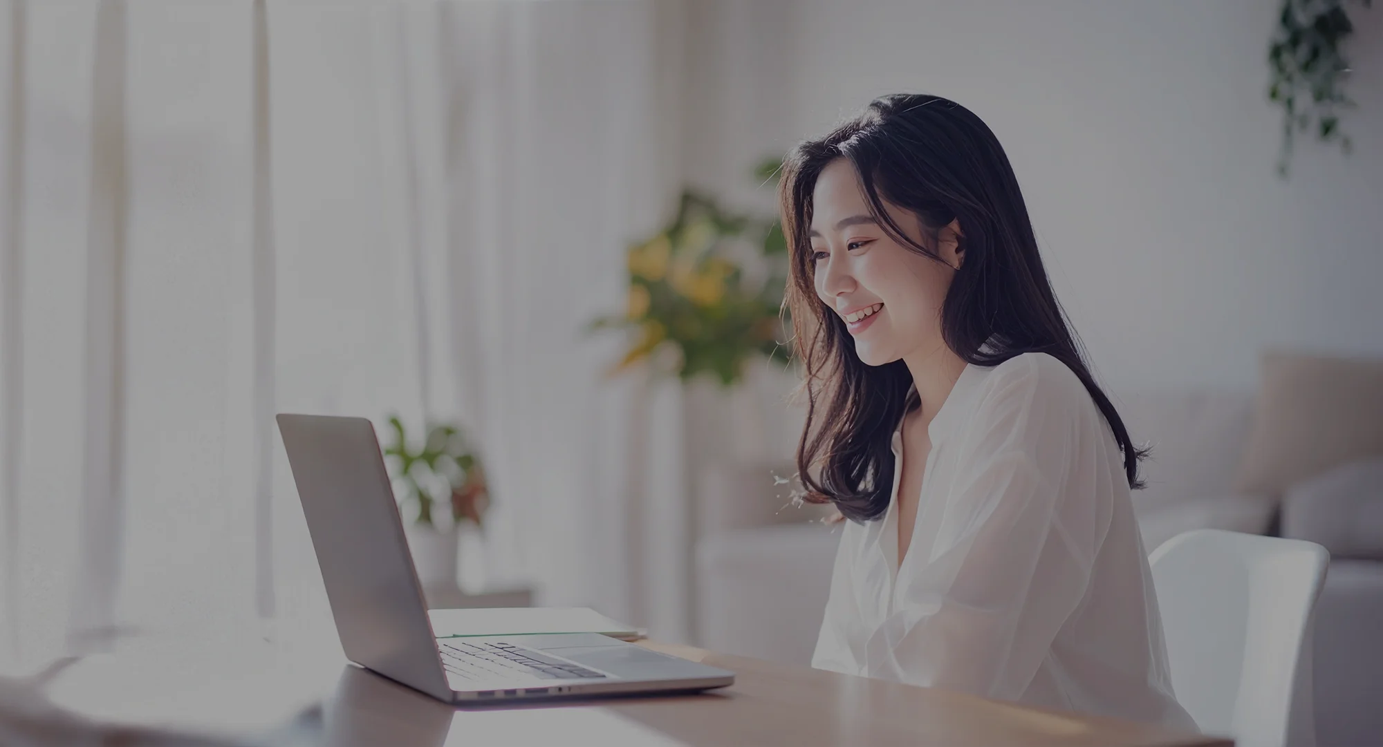 Woman using laptop with TIA